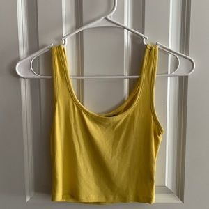 A yellow cropped tank top from shein that is a size xs